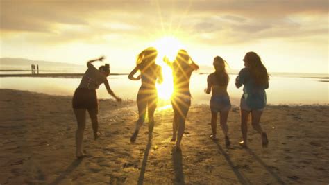 three girls celebrating the end of day with sunset in silhouette stock footage video 765166