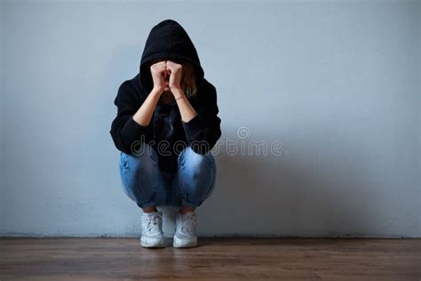 young girl hiding  face  hooded sweatshirt isolated   stock image image