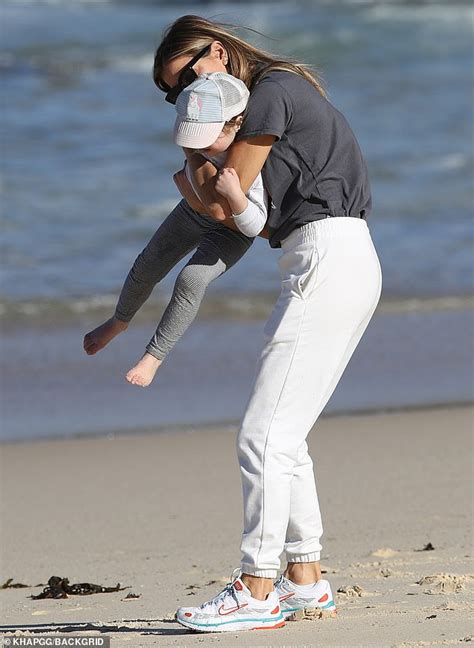 laura csortan enjoys a day at the beach with her three year old