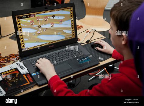 young man playing computer video game  asus laptop usa stock photo