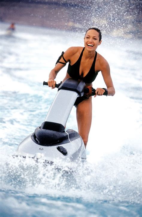 angelina was all smiles in her swimsuit as she played lara croft in sexy angelina jolie
