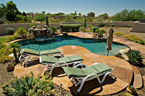 gorgeous stone patio desert landscaping  turquoise pool