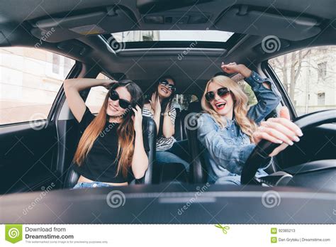 Three Girls Driving In A Convertible Car And Having Fun