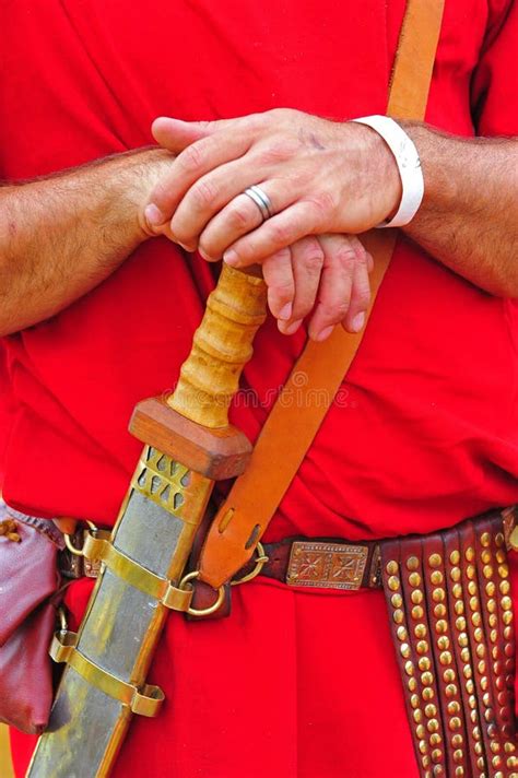 roman soldier rests  hands   sword stock photo image  celebrate entertainment