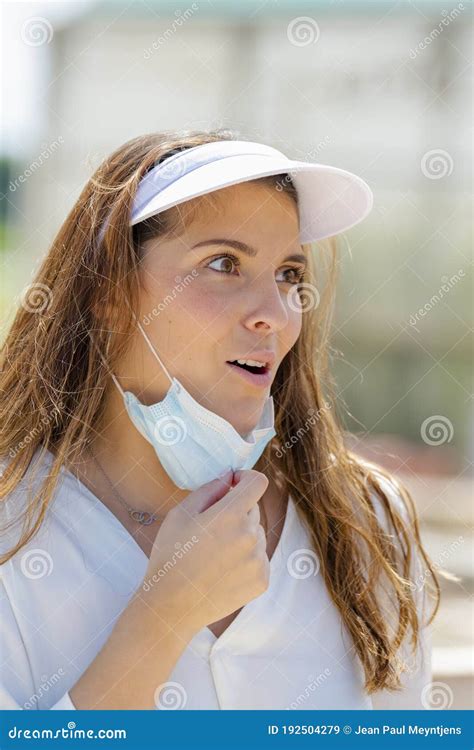 Young Woman Looking Surprised While Pulling Down Her Surgical Mask New