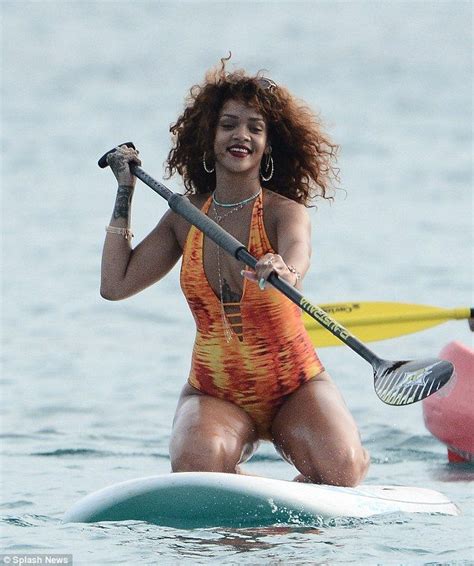 rihanna dons flame coloured swimsuit to paddle board in