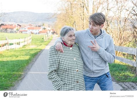Young Man And Old Woman Talking During A Walk A Royalty Free Stock