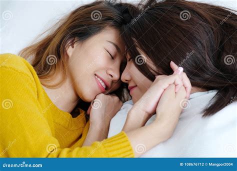 Lgbt Young Cute Asia Lesbians Lying And Smiling On White Bed To Stock