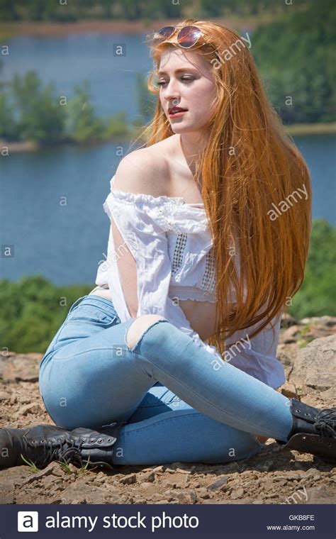 Beautiful Red Head Woman In Skinny Jeans Black Boots And
