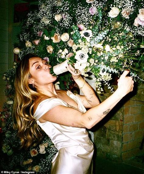 Miley Cyrus Pretends To Smoke A Bunch Of Flowers In Behind