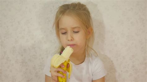 Young Girl Eating Banana Sitting At Home Stock Video Footage 00 28 Sbv