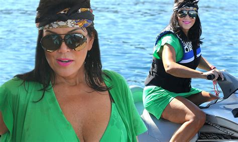kris jenner slips on a wig and flashes green bikini as she takes to the