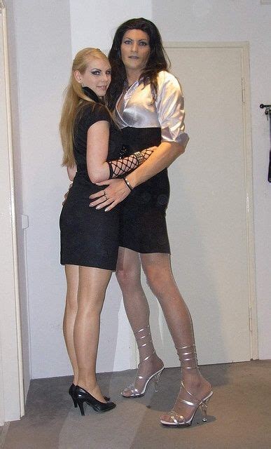 Two Women Standing Next To Each Other In High Heels