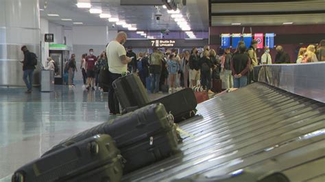 File People Wait At A Luggage Carousel In Harry Reid International