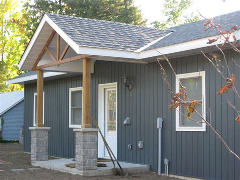 lake side cottage finished  midnight surf board  batten siding