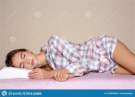 beautiful teen girl sleeping with orthopedic pillow on bed