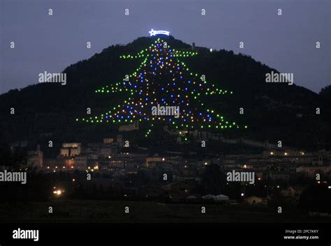 lights form  outline   christmas tree   slope  mount ingino overlooking
