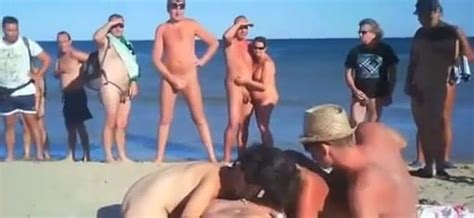four friends have sex on nude beach in front of crowd