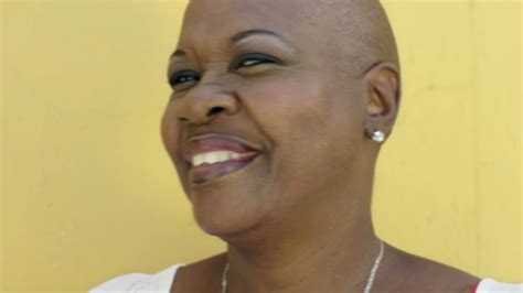 Portrait Of Mature Black Woman With Shaved Head Looking At