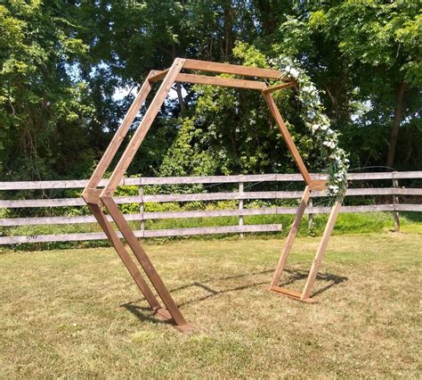 wooden geometric wedding arch    event rentals llc
