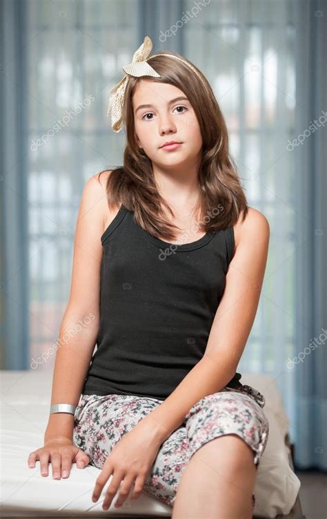 beautiful teen girl lying on bed and looking at camera
