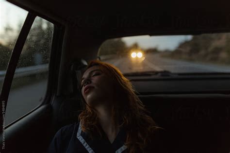 Ginger Woman Sleeping In A Car During A Road Trip By Thais Ramos Varela