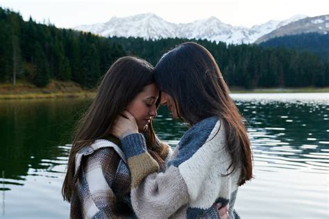 Young Lesbian Couple Sharing A Moment On A Dock By Stocksy