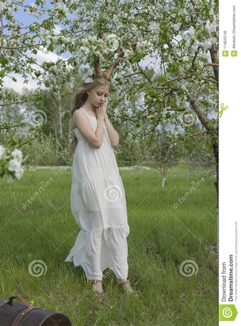 teen beautiful blonde girl wearing white dress with deer