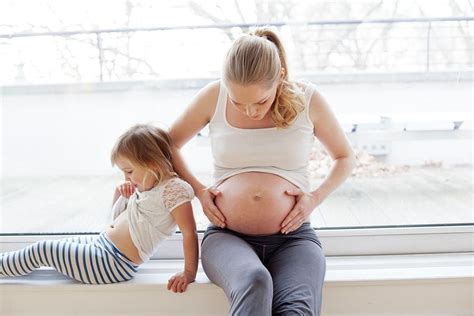 girl with pregnant mother photograph by ian hooton science photo