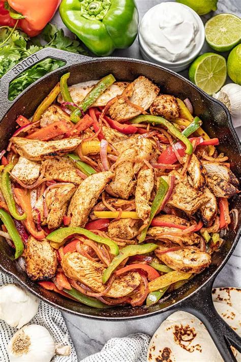 Chicken Fajitas In A Cast Iron Skillet With Multi Colored Bell Peppers