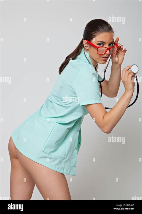 sexy woman doctor with a stethoscope and red glasses on white