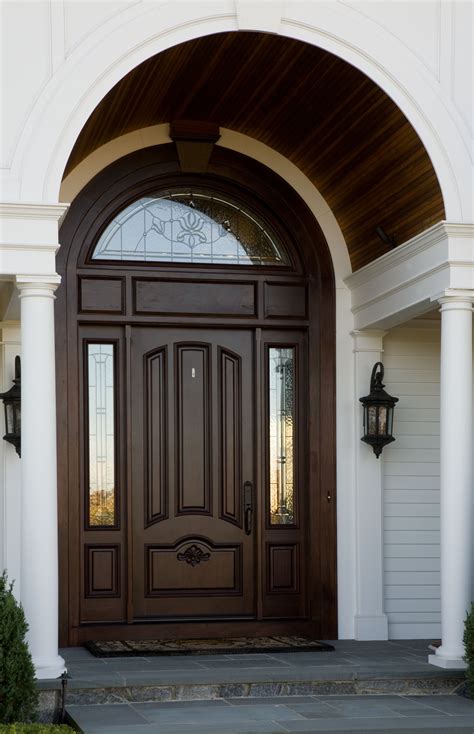 beautiful wooden arch accentuates  curved window   front entrance front door