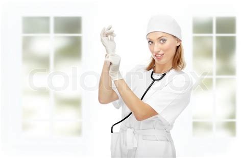 Pretty Female Doctor Putting On The Latex Gloves In The