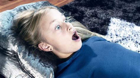 Scared And Surprised Girl Watching Scary Horror Movie In Tv Shot In