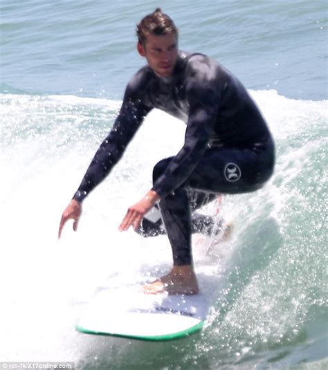 liam hemsworth shows off his cheeky side after a wetsuit malfunction during a day of surf in