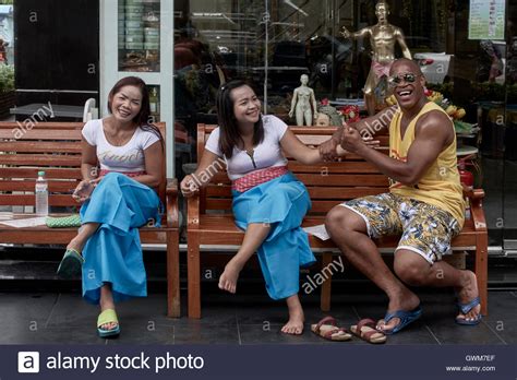 african man amusing the girls at a thai massage parlor thailand s