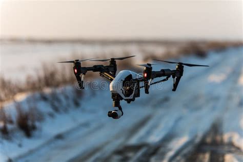 white drone  digital camera flying  landing  snow stock photo image  activities