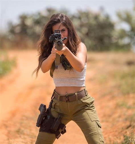 A Female Israeli Combat Soldier Proudly Models For Weapons