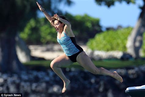 mariska hargitay sports low cut striped swimsuit as she makes a splash on hawaii beach break