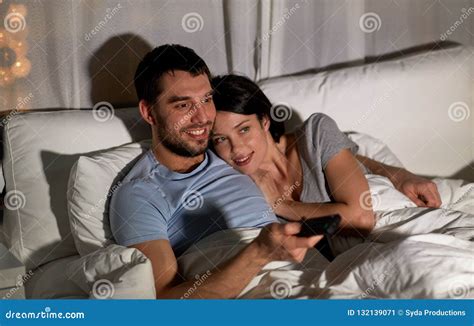 Happy Couple Watching Tv In Bed At Night At Home Stock Image Image Of