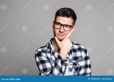 handsome young man standing    isolated   gray