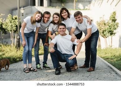 happy family white tshirt jeans emracing stock photo  shutterstock
