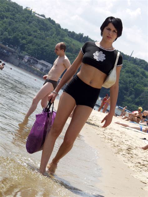 short haired brunette is undressing at public beach russian sexy girls