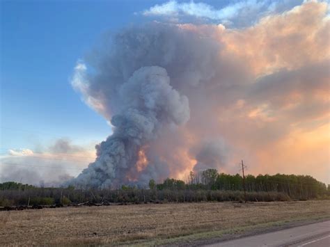 firefighters conduct firing operation  protect town  high level alberta wildfire today