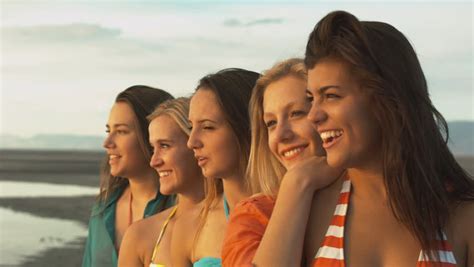 group of five happy teenage girls walk up look into the sun on the beach stock footage video