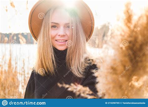 European Blonde Woman With Beige Hat In Black Sweater In The