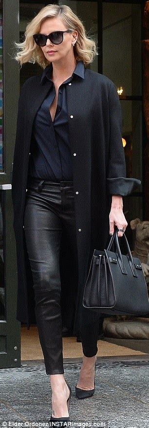 charlize theron shows off legs in leather leggings in nyc