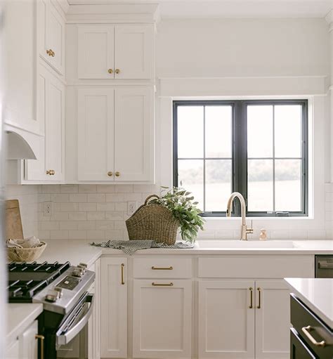 black casement windows  kitchen sink complement dark colored island pella