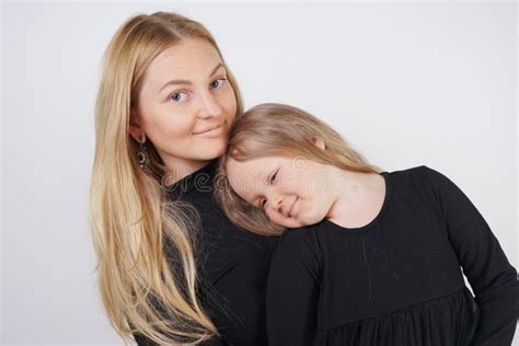 Cute Kind Caucasian Blonde Mom And Daughter Posing On White Background