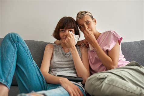 Sad Lesbian Girls Watching Tv And Crying On Sofa Stock Image Image Of